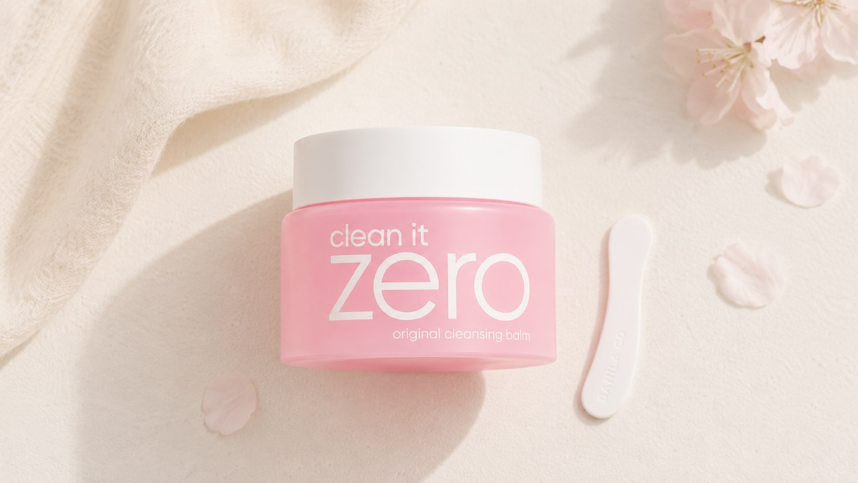 Banila Co Clean It Zero Cleansing Balm pink jar on neutral cream background with spatula