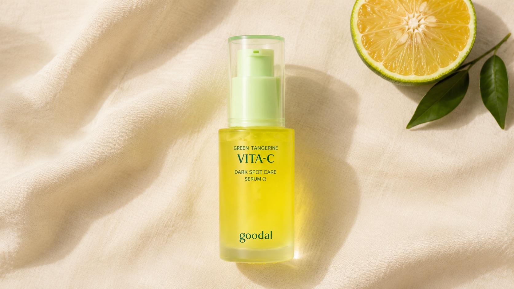 Goodal Green Tangerine Vita C Dark Spot Serum bottle with green tangerine fruit on neutral background