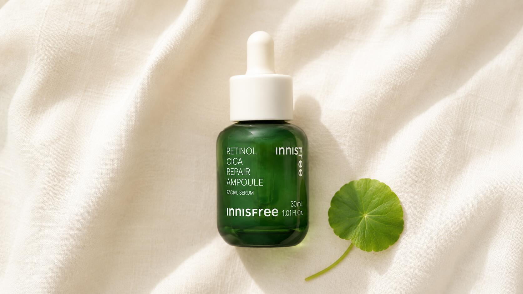 Innisfree Retinol Cica Repair Ampoule green glass bottle with dropper on clean cream surface