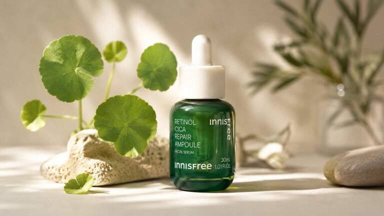 Innisfree Retinol Cica Repair Ampoule green bottle with centella leaves on cream background