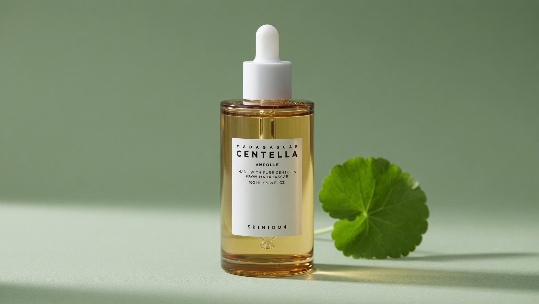 Skin1004 Madagascar Centella Ampoule bottle on green leaf background