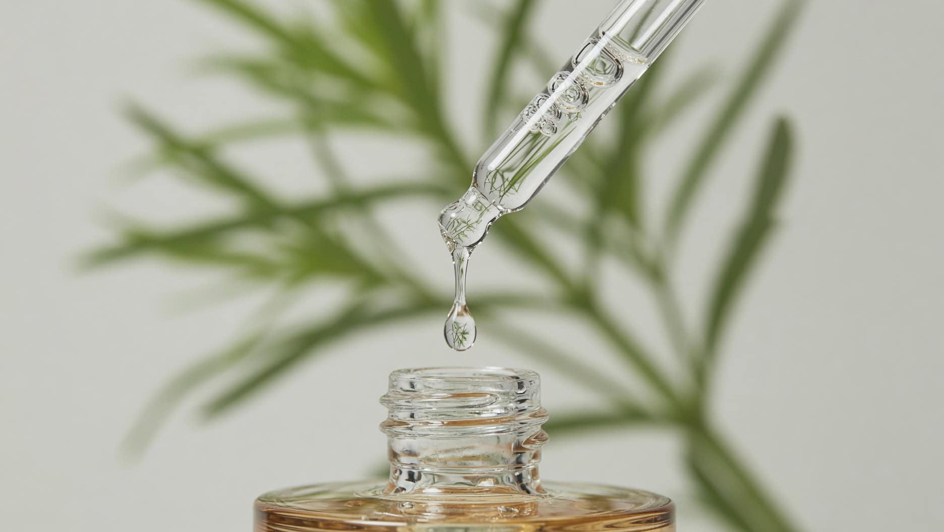 Skin1004 Centella Ampoule clear watery serum on dropper tip with green plant accent