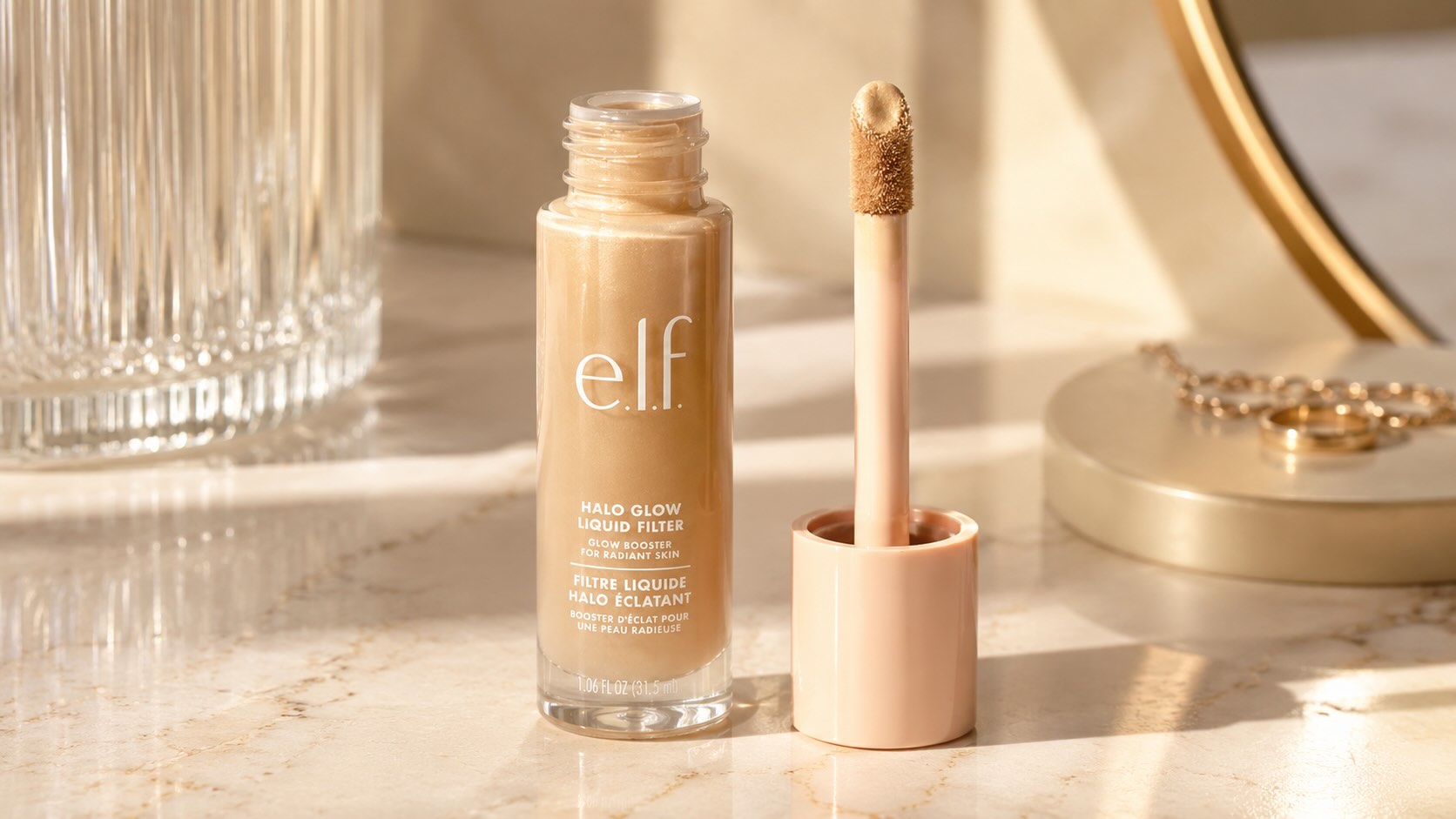 e.l.f. Halo Glow Liquid Filter dropper bottle on cream marble background