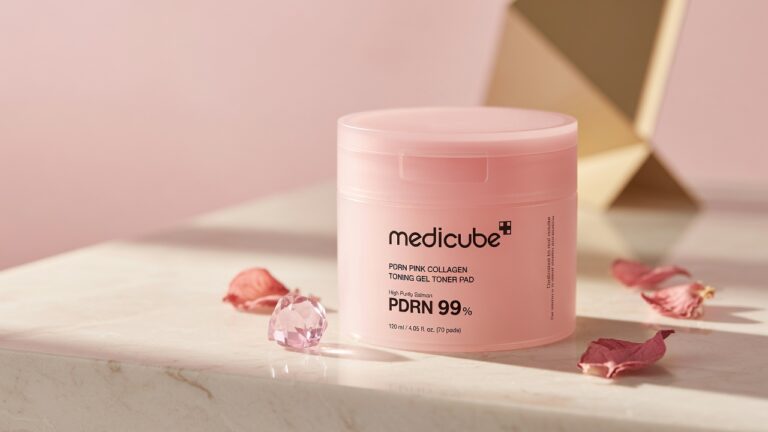 medicube PDRN Pink Collagen Gel Toner Pads pink jar on cream marble with rose petal K-beauty styling