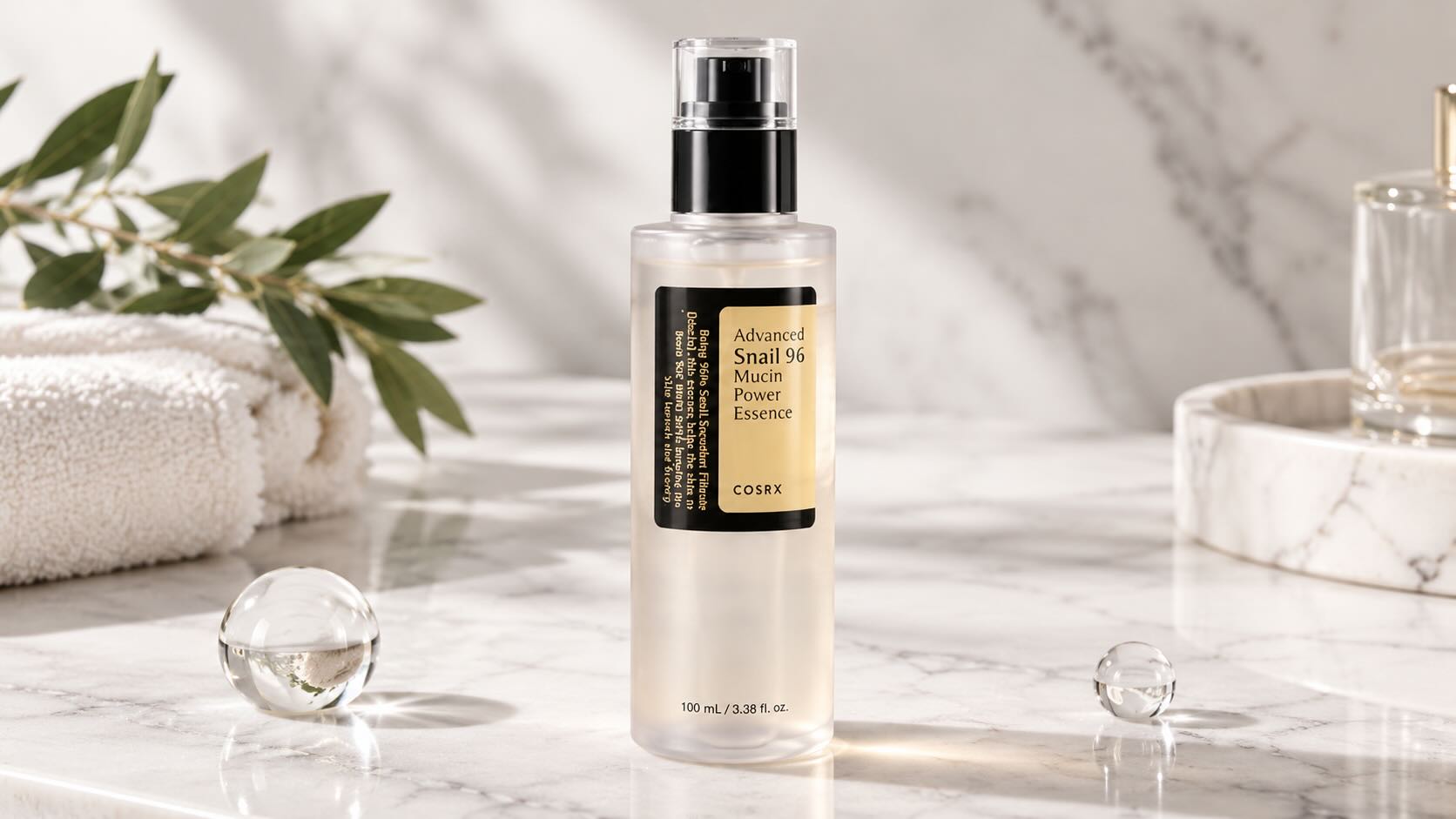 COSRX Advanced Snail 96 Mucin Power Essence bottle on clean white surface with minimal K-beauty editorial styling