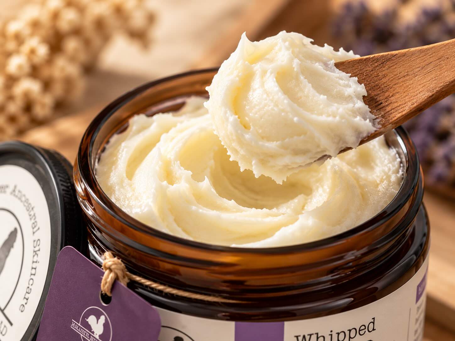 Hearth and Homestead Whipped Beef Tallow Balm whipped texture on fingertips showing the thick rich occlusive consistency