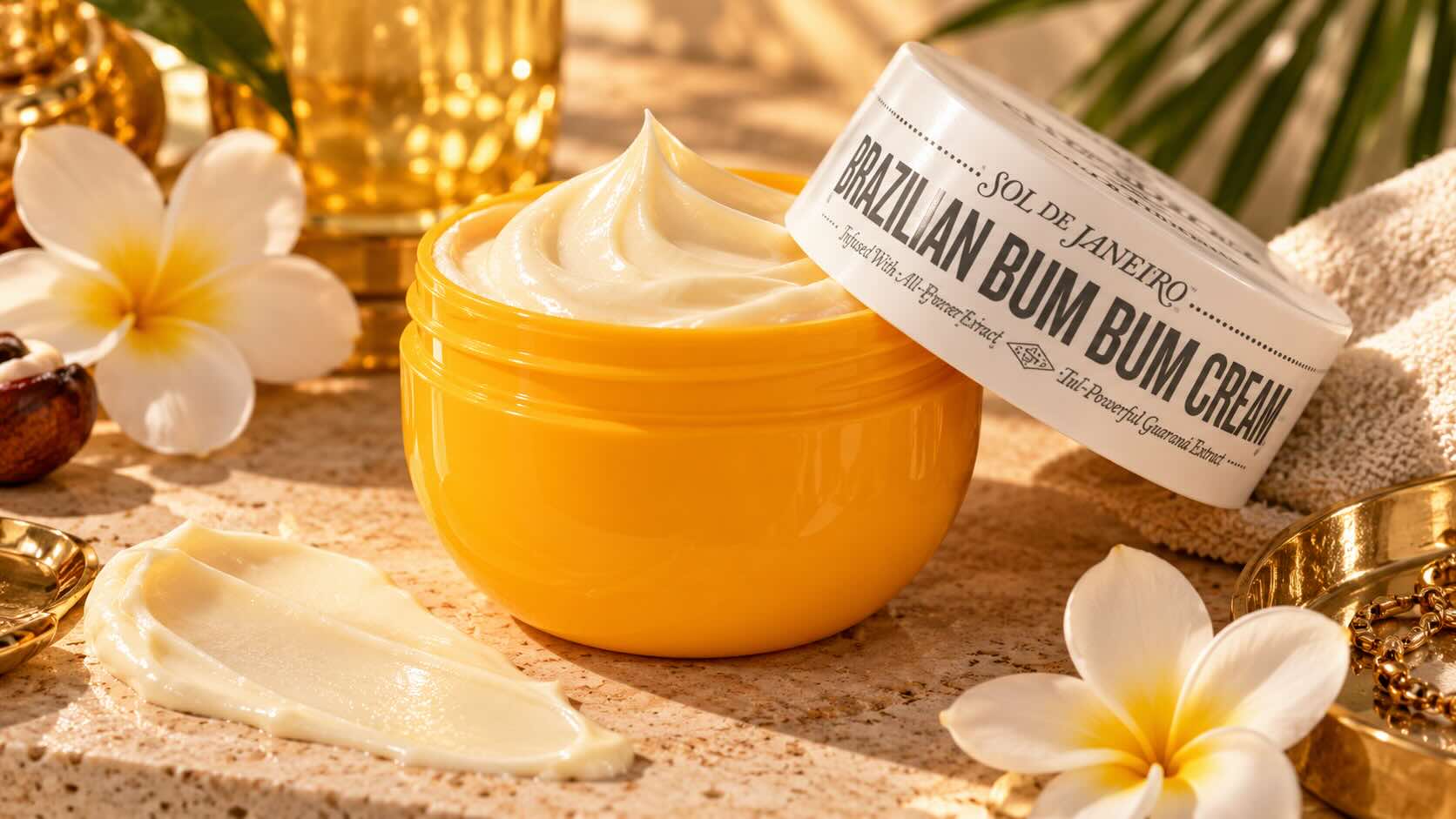 Sol de Janeiro Brazilian Bum Bum Cream jar on warm-toned editorial surface with soft golden light — holiday season body care hero product